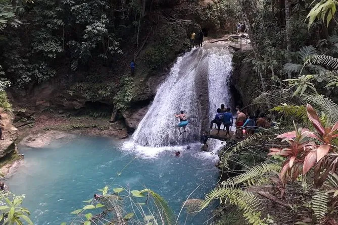 Visitors climbing the cascading tiers of Dunn's River Falls on a popular Ocho Rios excursion in Jamaica