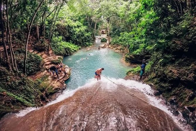 Tourist floating on a tube through tropical jungle on the White River river tubing excursion in Ocho Rios Jamaica