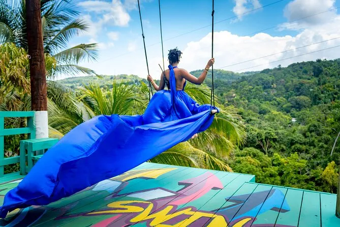 Woman in a flowing flying dress soaring on the Bali-inspired jungle swing on a unique Ocho Rios excursion Jamaica